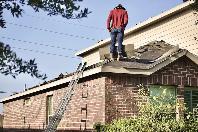 Professional roofer working on a residential roof in East Falmouth